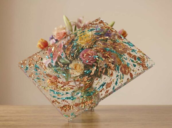 Premium transparent acrylic block with dense gold and green embedded flakes for custom design projects.