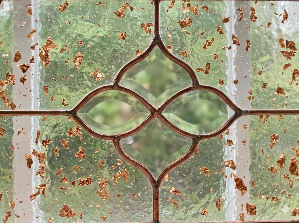 Custom transparent acrylic sheet with embedded gold flakes, applied as decorative window glass for high-end architectural projects.