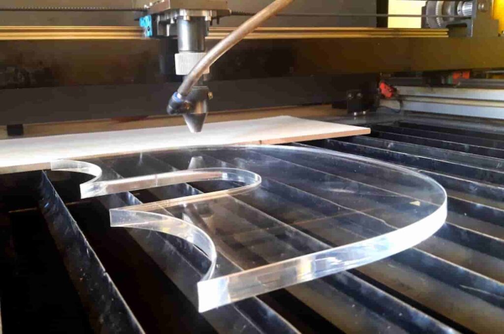 A thick, transparent acrylic piece with smooth, laser-cut edges showcasing high-precision industrial fabrication.